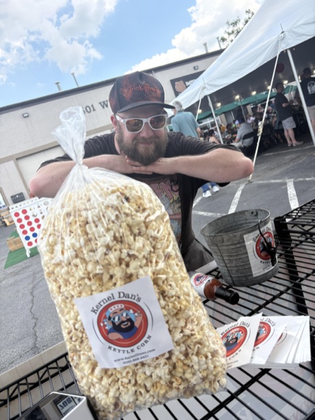 A crew member admiring a party bag at a brewery fest