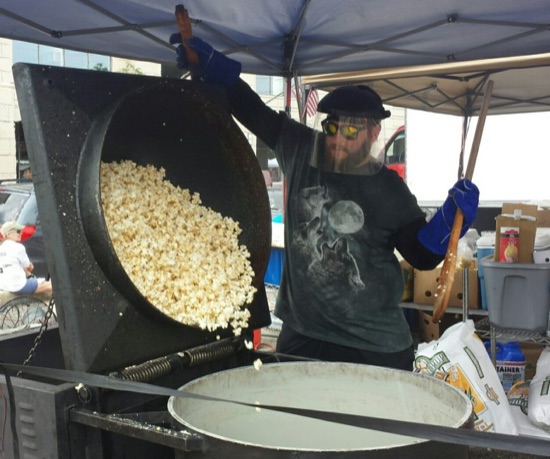 Popping a fresh batch in the kettle under the tent