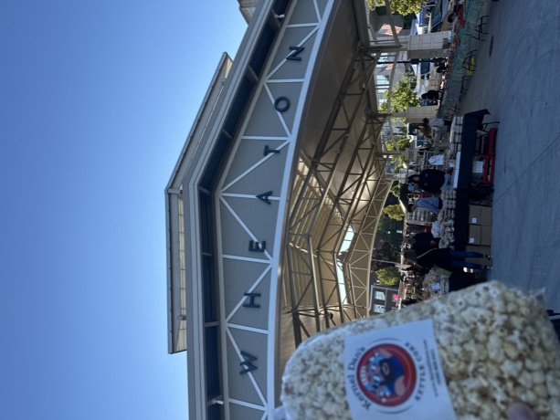A bag of kettle corn in front of the Wheaton French Market pavilion